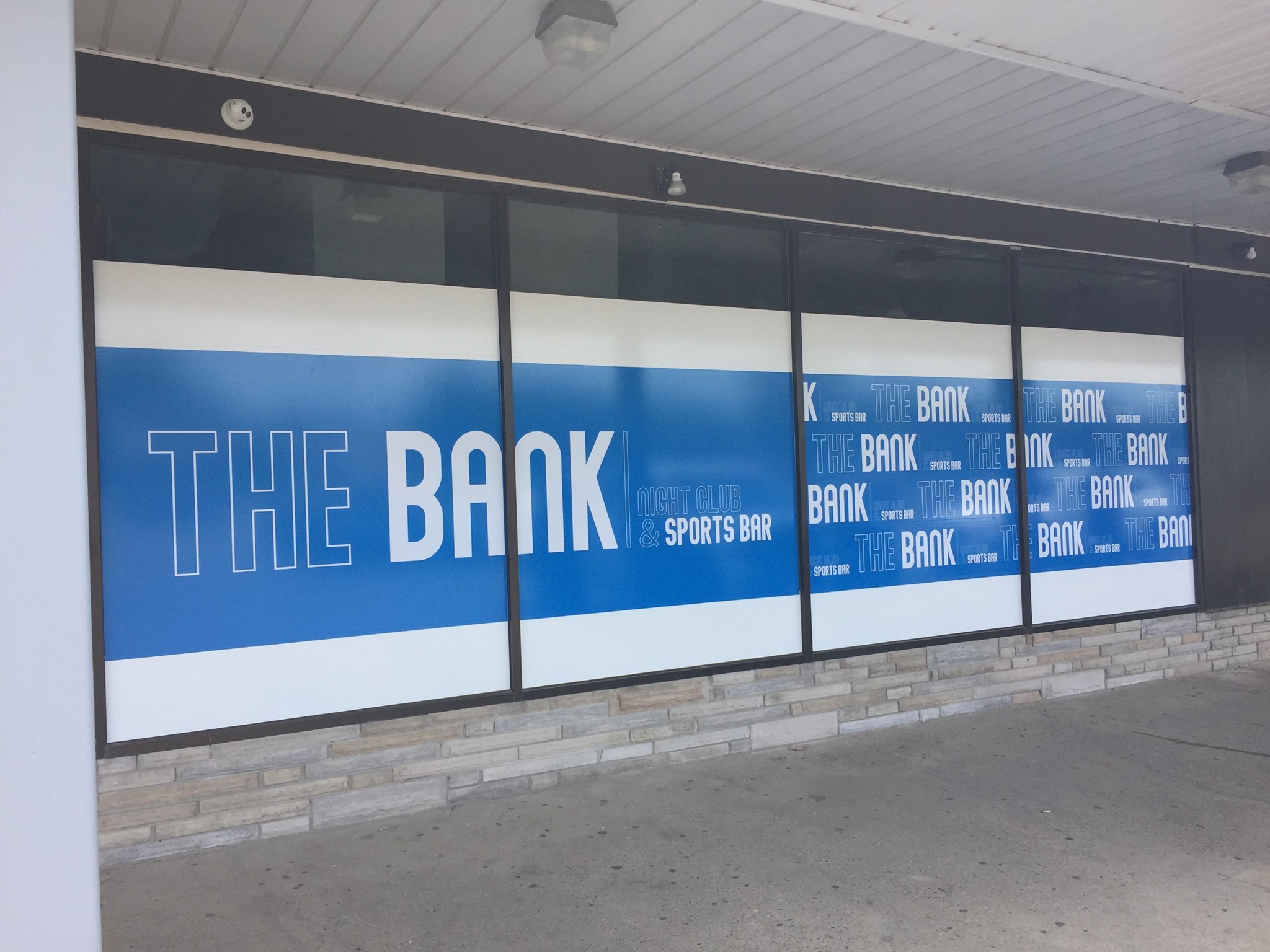 Custom storefront window graphics installation by Jackson Signs